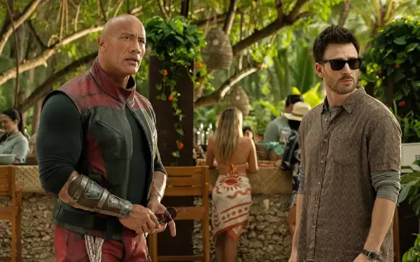 Dwayne Johnson and Chris Evans star in Red One, captured in this vibrant 4K Ultra HD wallpaper, set against a lush tropical backdrop.