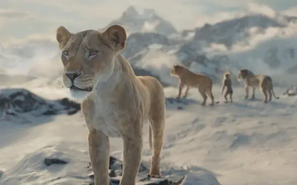 HD PC desktop wallpaper featuring a realistic lioness in a snowy landscape from the movie Mufasa: The Lion King, with other lions in the background.