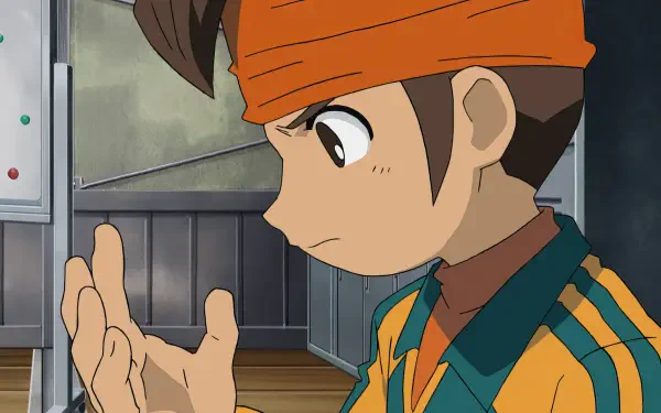 A character from the anime Inazuma Eleven, shown with an orange headband and striped jacket, gazes thoughtfully at his hand, set against a classroom background. HD PC wallpaper.