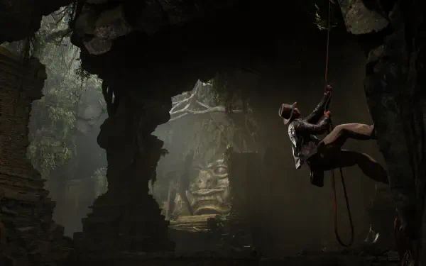 An adventurous scene from Indiana Jones and the Great Circle, featuring Indiana Jones descending into a shadowy cave, surrounded by ancient ruins and dramatic lighting. HD PC wallpaper.