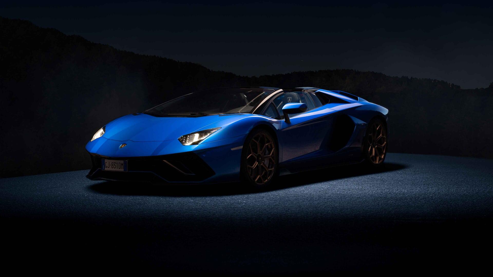 Blue Lamborghini sports car in dramatic low-key lighting on a dark backdrop, presented as a 4K Ultra HD PC desktop wallpaper and background.
