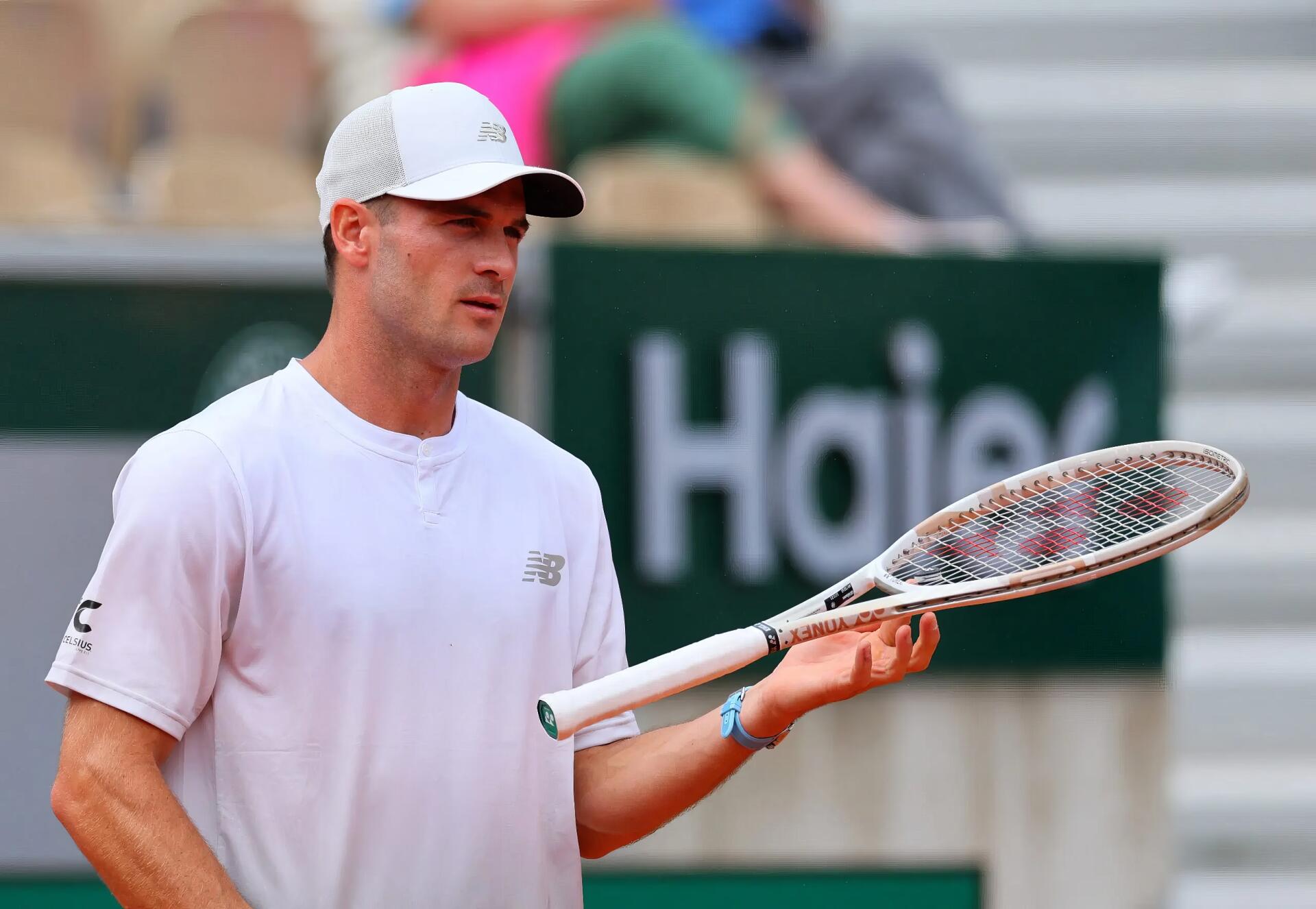 HD desktop wallpaper featuring tennis player Tommy Paul holding a racket on the court during a match.