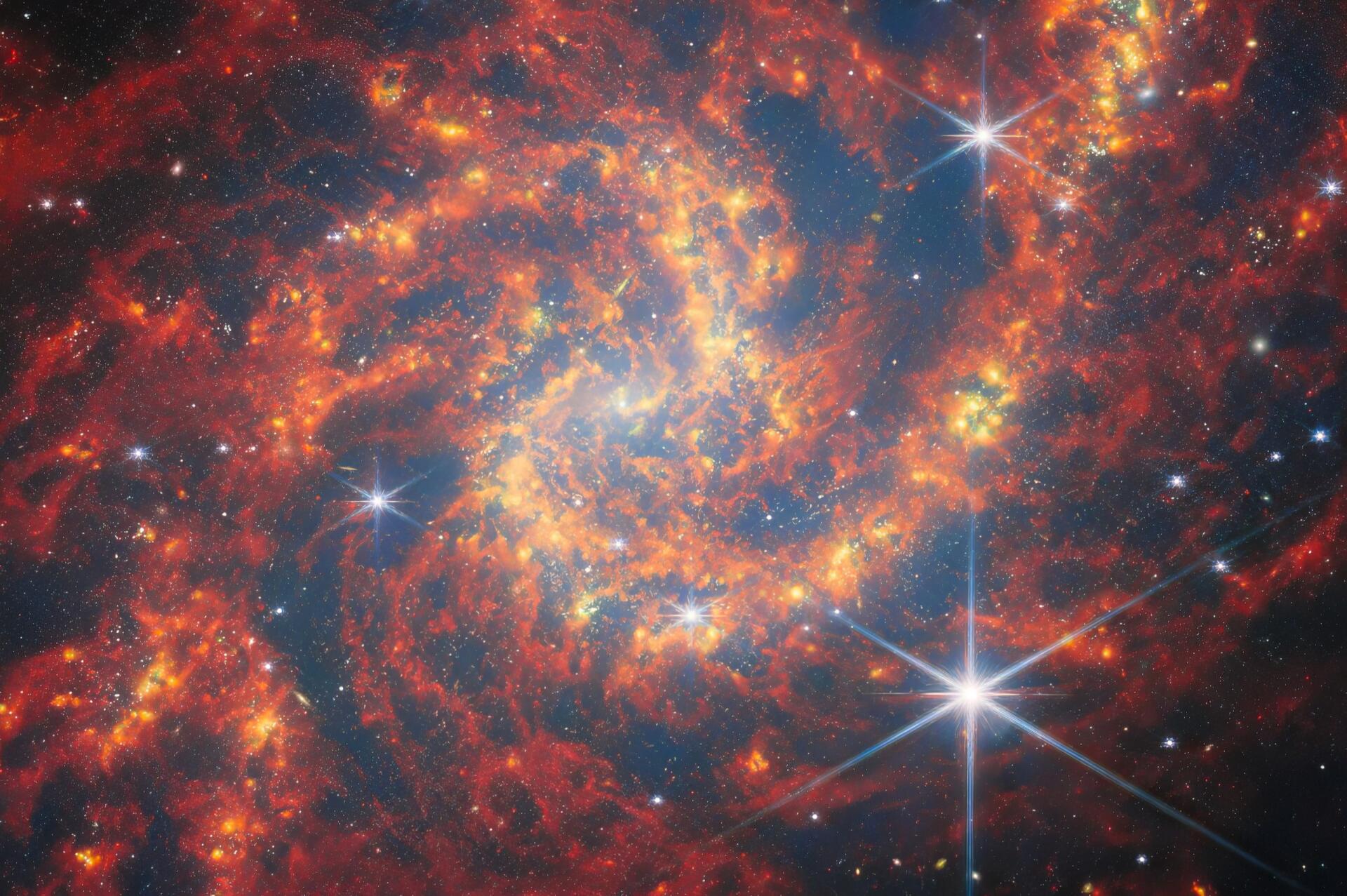 HD desktop wallpaper featuring a vibrant galaxy captured by the James Webb Space Telescope, showcasing stars and a vivid sci-fi space landscape.