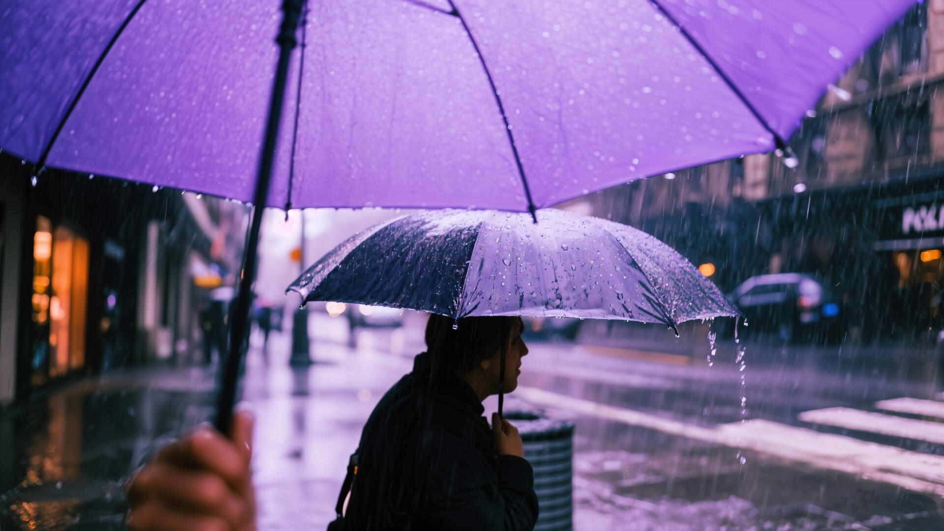 4K Ultra HD desktop wallpaper showing a rainy city street with people walking under umbrellas in wet weather.