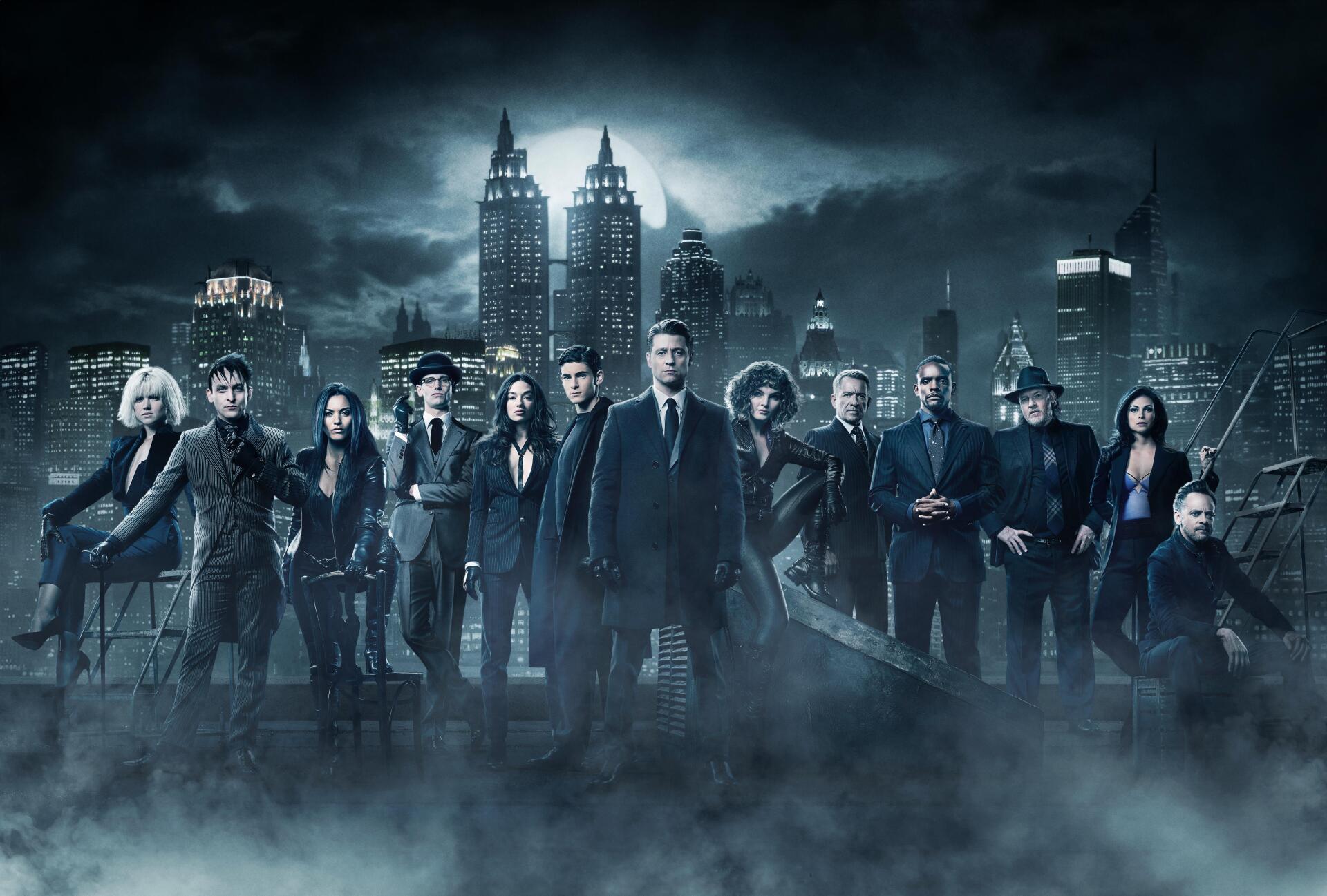 Gotham TV show characters stand in front of the city skyline under a dark, cloudy sky in this 4K Ultra HD PC desktop wallpaper and background.