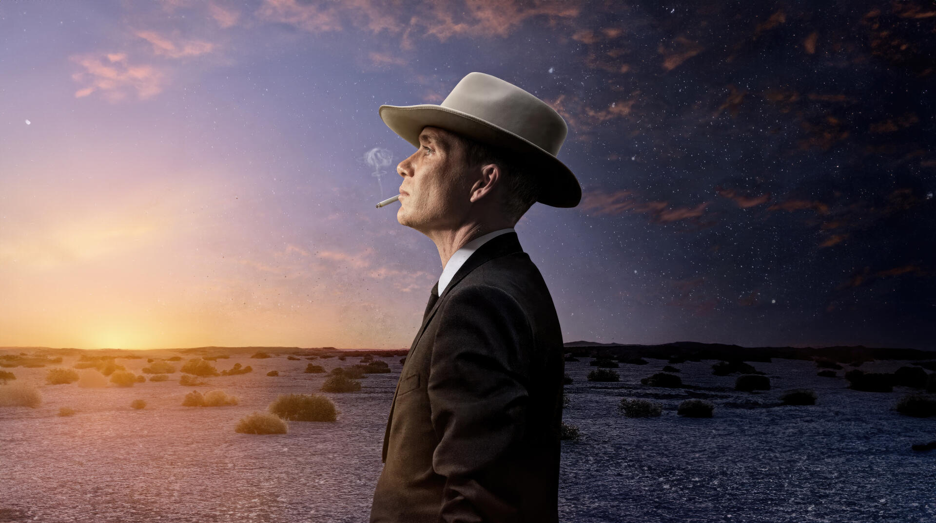 Oppenheimer-inspired 4K Ultra HD PC desktop wallpaper: man in suit and fedora smoking, gazing across a barren desert at a golden sunset beneath dramatic clouds.