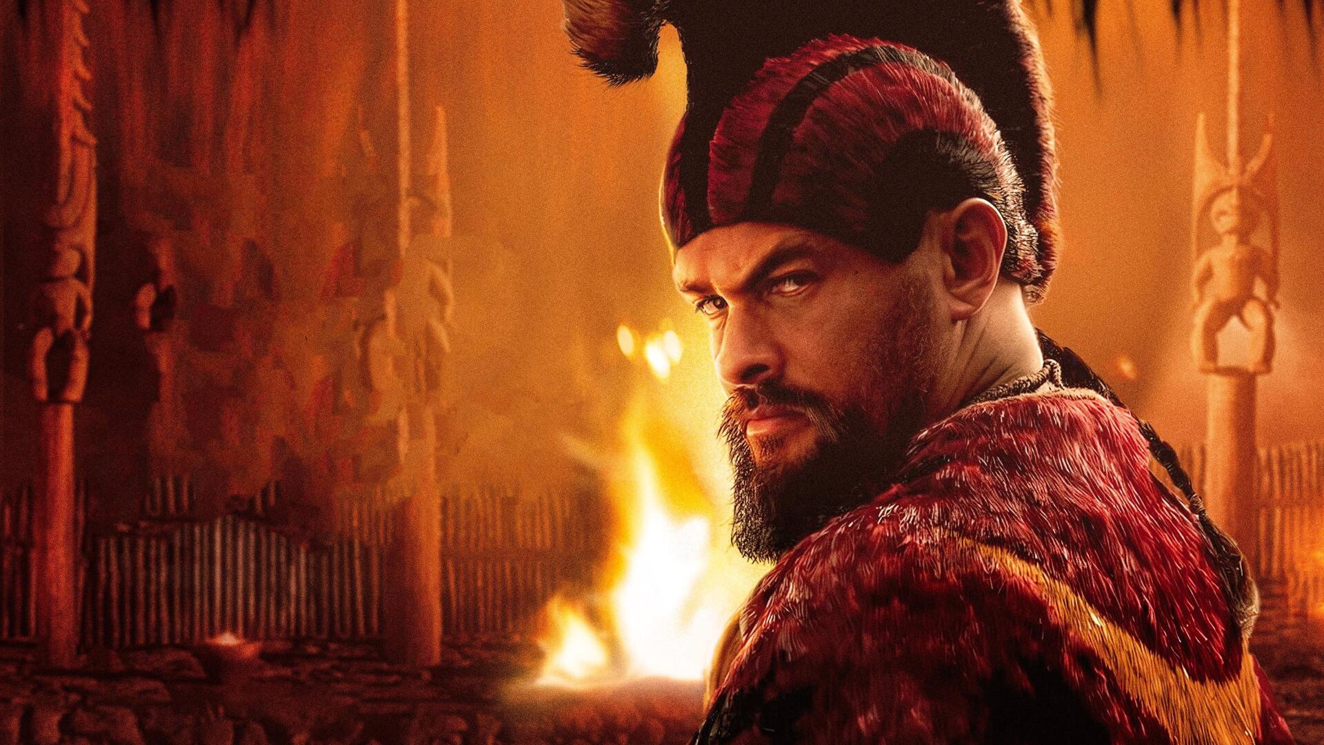 4K Ultra HD PC desktop wallpaper of a stern, bearded Chief of War in red fur-trimmed armor and horned cap, glancing over his shoulder in a torchlit hall with a roaring fire.