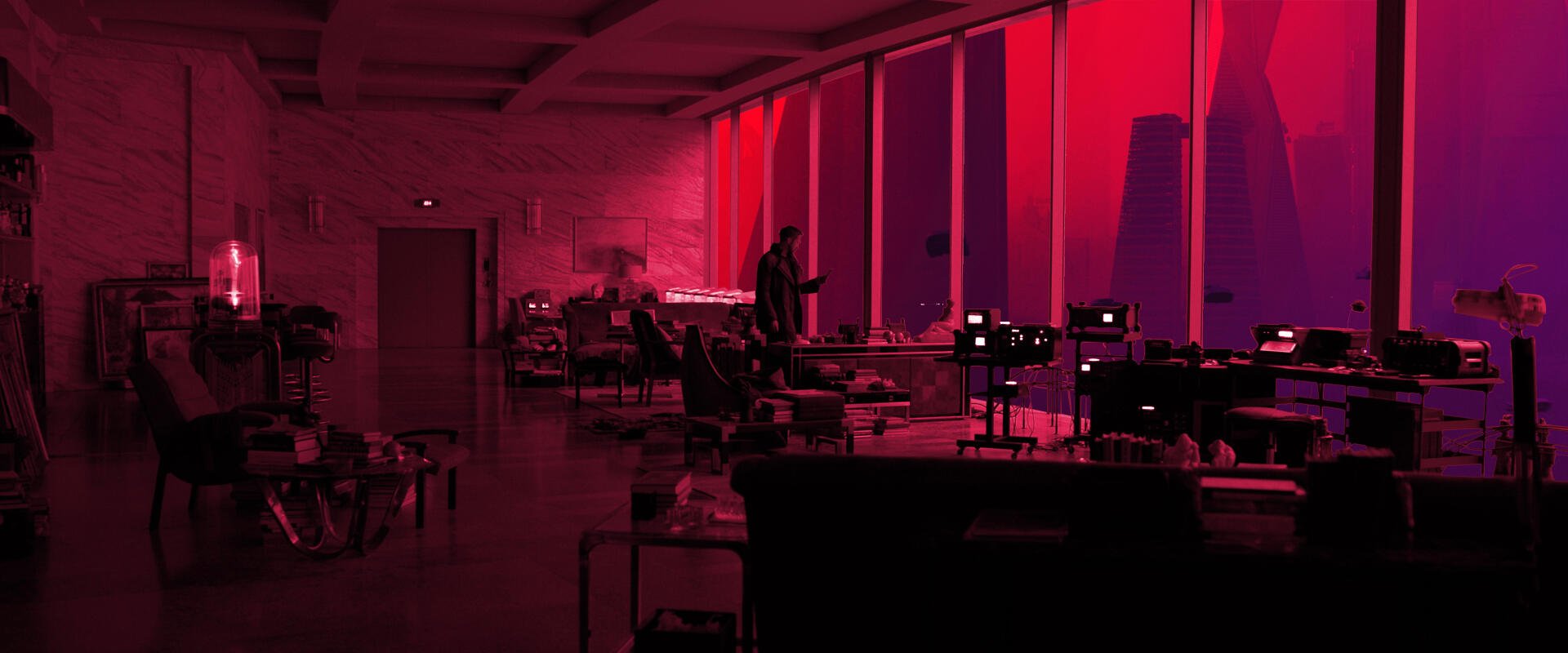 HD PC desktop wallpaper from the movie Blade Runner 2049: neon-red office interior, silhouetted figures and retro-futuristic desks framed by tall windows.
