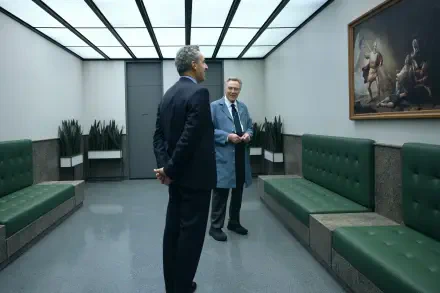 Two men in suits stand in a modern, minimalist room with green benches, gazing at a painting. This striking image from the TV show Severance serves as an 8K Ultra HD desktop wallpaper.