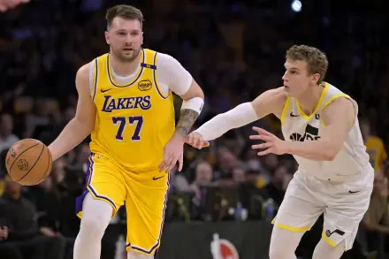 A dynamic moment in basketball featuring NBA players Luka Dončić in a Lakers jersey and Lauri Markkanen, captured in high-definition for an engaging desktop wallpaper.