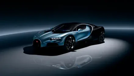 A sleek Bugatti hypercar, the Bugatti Tourbillon, showcased in a dramatic 4K Ultra HD setting, highlighting its striking design against a dark background.