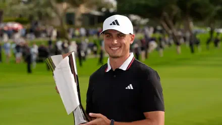 Ludvig Åberg smiles while holding a trophy on a vibrant golf course, showcasing his achievement in the sport. This 4K Ultra HD image serves as a striking desktop wallpaper.