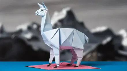 A 4K Ultra HD wallpaper featuring a stylized origami alpaca, set against a blurred mountain backdrop, showcasing intricate folds and vibrant colors.