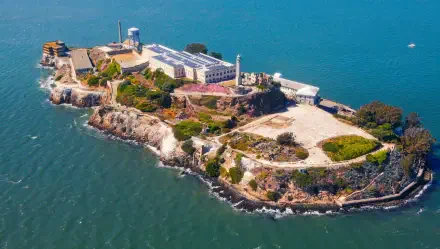 Aerial view of Alcatraz Island in California surrounded by blue waters, captured in high definition for a vibrant PC desktop wallpaper.