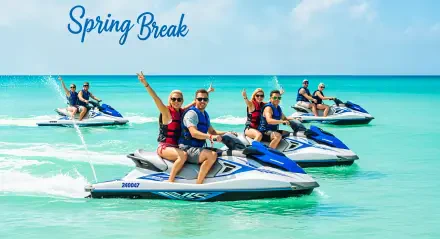 Five people enjoying jet skiing on clear turquoise water under a sunny blue sky, captured in a vibrant 4K Ultra HD spring break PC desktop wallpaper.