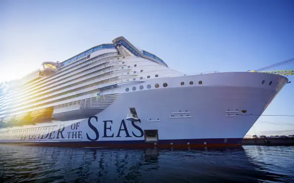 A majestic Royal Caribbean cruise ship, 'Wonder of the Seas,' is docked with a clear blue sky in the background, showcasing its grandeur in this stunning 4K Ultra HD desktop wallpaper.