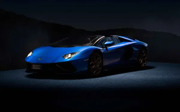 Blue Lamborghini sports car in dramatic low-key lighting on a dark backdrop, presented as a 4K Ultra HD PC desktop wallpaper and background.