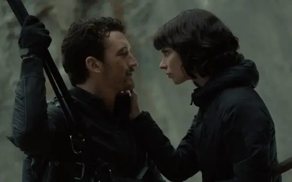 A scene from the movie The Gorge (2025) featuring Miles Teller and Sigourney Weaver, capturing an intense moment between the characters. 8K Ultra HD desktop wallpaper.