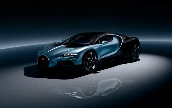 A sleek Bugatti hypercar, the Bugatti Tourbillon, showcased in a dramatic 4K Ultra HD setting, highlighting its striking design against a dark background.