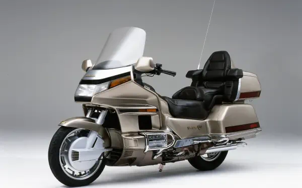 A sleek 25YM Honda GL 1800 Gold Wing motorcycle showcased against a minimalist background, designed as a high-definition PC desktop wallpaper and background.