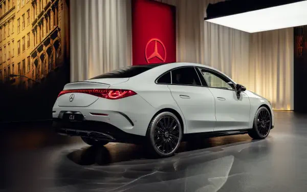 A sleek white Mercedes-Benz CLA parked in a stylish setting, showcasing its modern design and luxury features against an elegant backdrop. 4K Ultra HD desktop wallpaper.