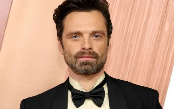 Sebastian Stan at the Academy Awards, showcasing a dapper look in a tuxedo, exuding charm against a sophisticated backdrop. Ideal for a 4K Ultra HD desktop wallpaper.