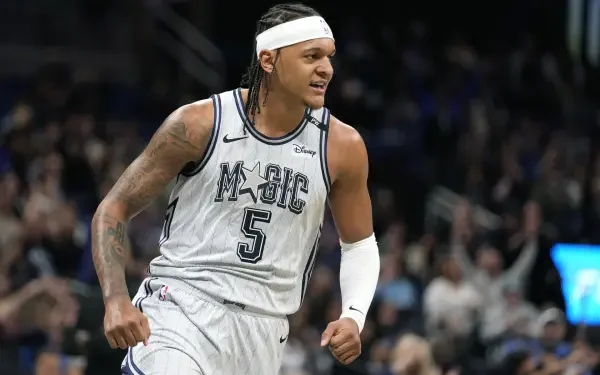 HD desktop wallpaper featuring Orlando Magic player Paolo Banchero celebrating during an NBA game, capturing the energy and excitement of basketball.