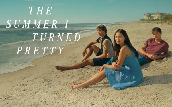 HD desktop wallpaper featuring three characters from the TV show The Summer I Turned Pretty sitting on a sandy beach under a clear sky.