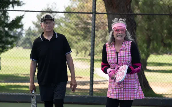 Scene from the movie Freakier Friday featuring Jamie Lee Curtis on a tennis court, captured in vibrant 8K Ultra HD PC desktop wallpaper quality.