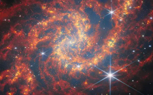 HD desktop wallpaper featuring a vibrant galaxy captured by the James Webb Space Telescope, showcasing stars and a vivid sci-fi space landscape.