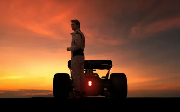 Brad Pitt stands beside an F1 car at sunset in this 8K Ultra HD F1 (2025) desktop wallpaper, capturing a dramatic and cinematic racing moment.
