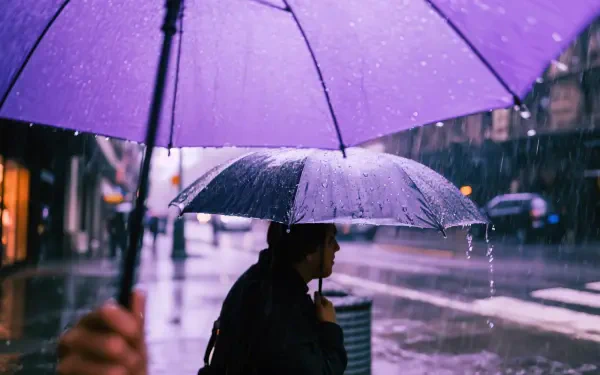 4K Ultra HD desktop wallpaper showing a rainy city street with people walking under umbrellas in wet weather.