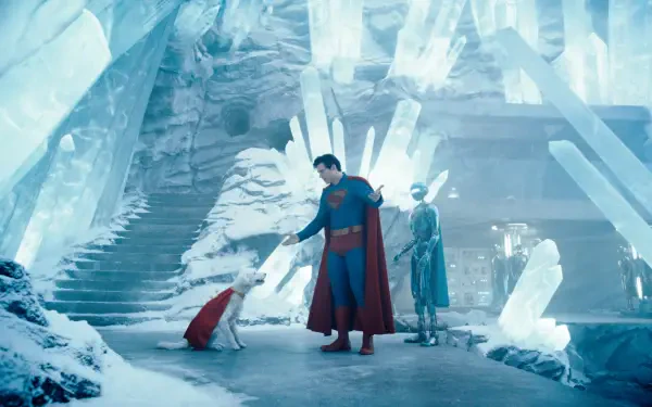 Superman (2025) stands in an icy cavern with crystalline structures, accompanied by two figures, captured in stunning 4K Ultra HD for a PC desktop wallpaper.