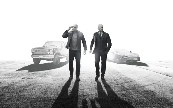 Fast & Furious Presents: Hobbs & Shaw HD PC desktop wallpaper — black-and-white image of two men walking toward the camera with a truck and car behind, casting long shadows.
