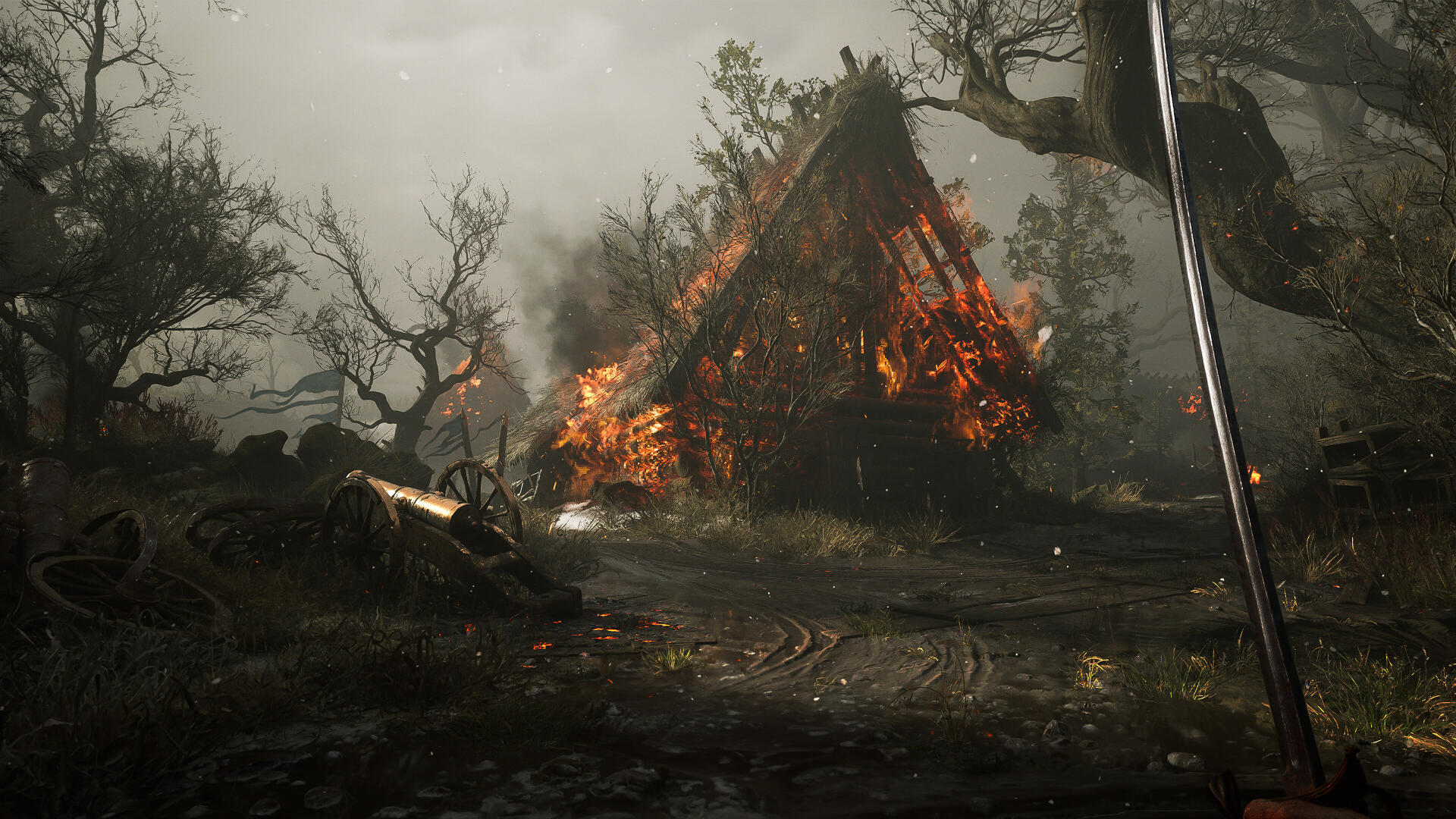 4K Ultra HD PC desktop wallpaper from the video game Valor Mortis: a burning A-frame house amid charred trees and a smoky battlefield, embers glowing beneath a stormy sky.