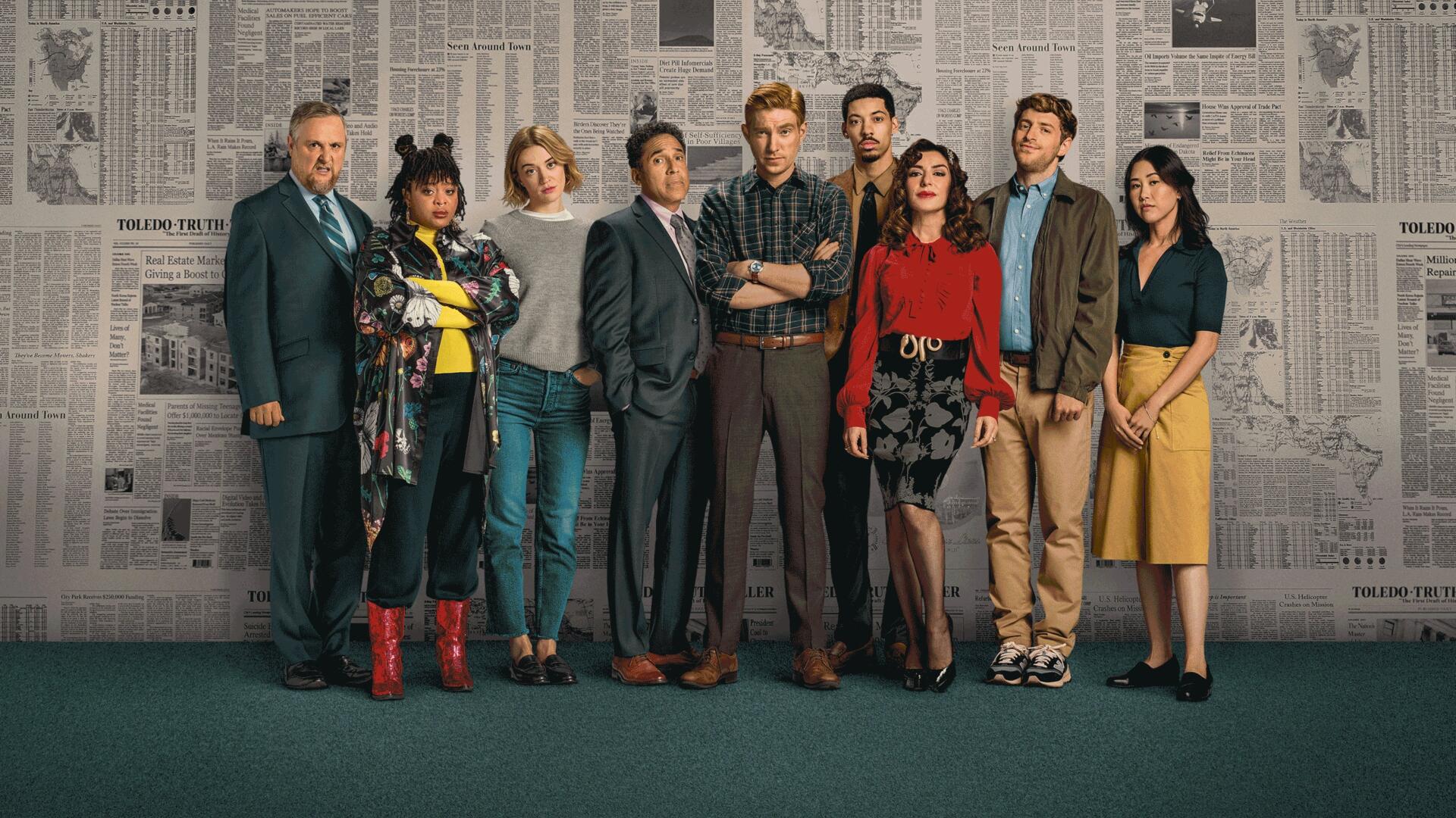 Promotional group portrait for The Paper of eight newsroom staff against a newspaper-covered wall — 4K Ultra HD PC Desktop Wallpaper and Background.