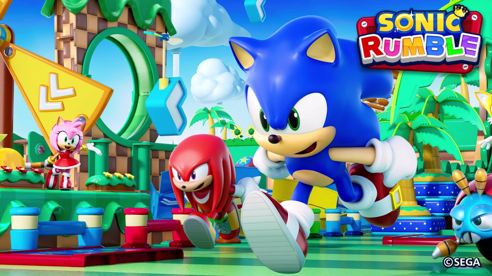 Vibrant Sonic Rumble video game 2K Quad HD PC desktop wallpaper showing Sonic, Knuckles and Amy racing across a colorful looped track with rings, palm trees and geometric platforms.