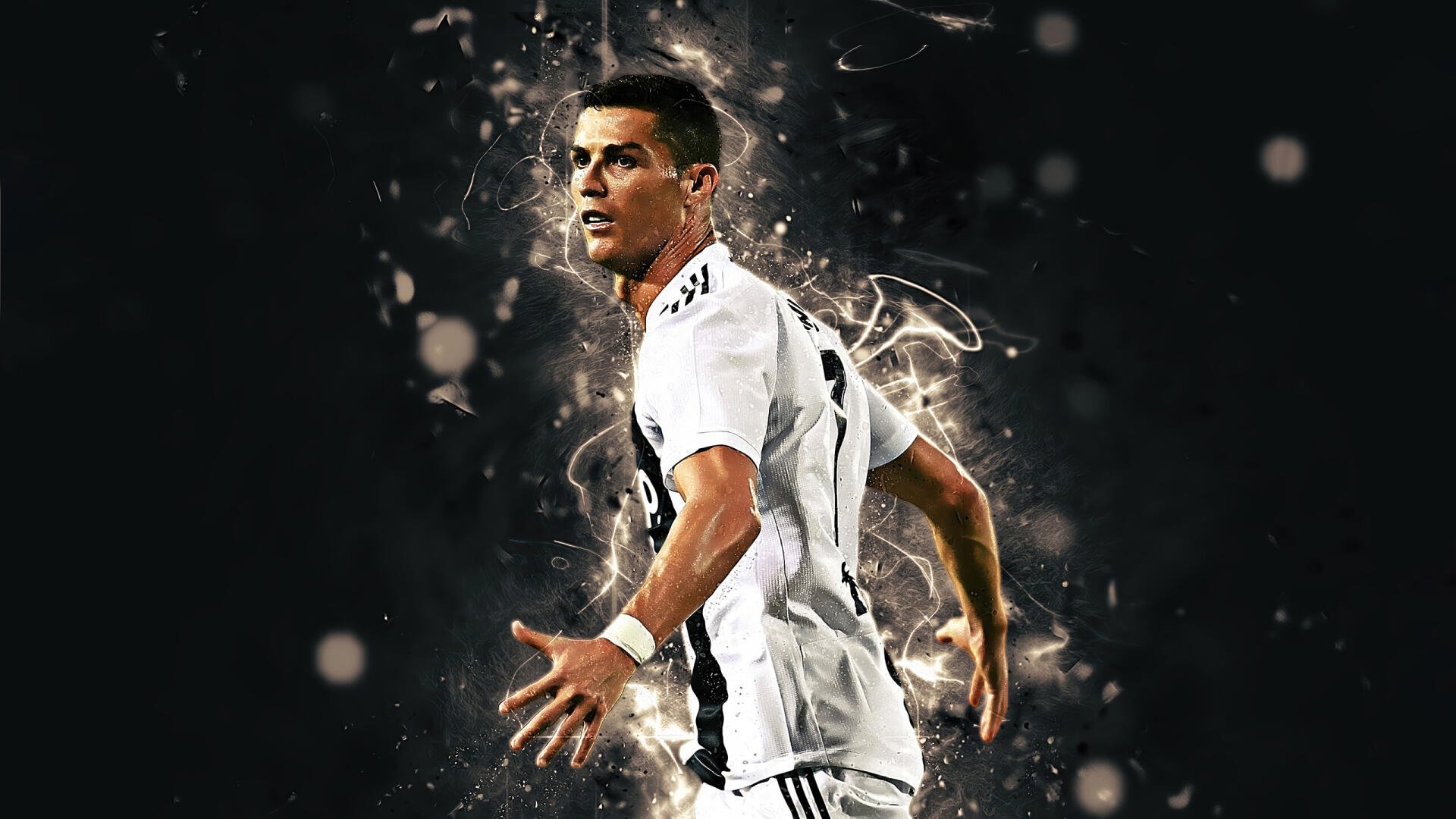 Sports-themed 2K Quad HD desktop wallpaper of a footballer in a Juventus F.C. kit striking a dramatic pose amid glowing, explosive energy effects.
