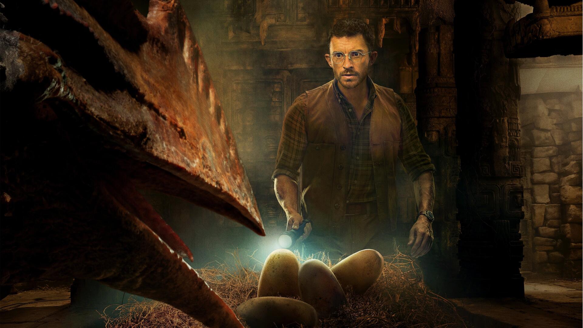 Jurassic World Rebirth 4K Ultra HD PC desktop wallpaper: tense hatchery scene with a man watching glowing dinosaur eggs as a raptor peers over them.