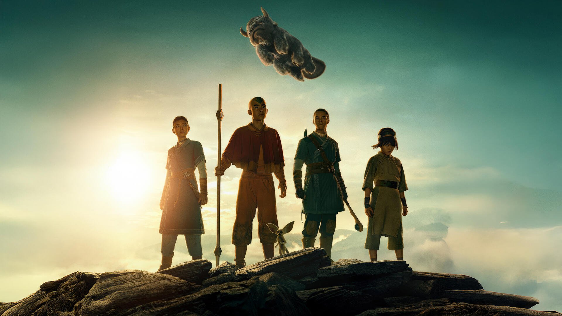 Avatar: The Last Airbender 4K Ultra HD PC desktop wallpaper — Aang and three companions stand on a cliff, Appa flying above against a golden sunrise.