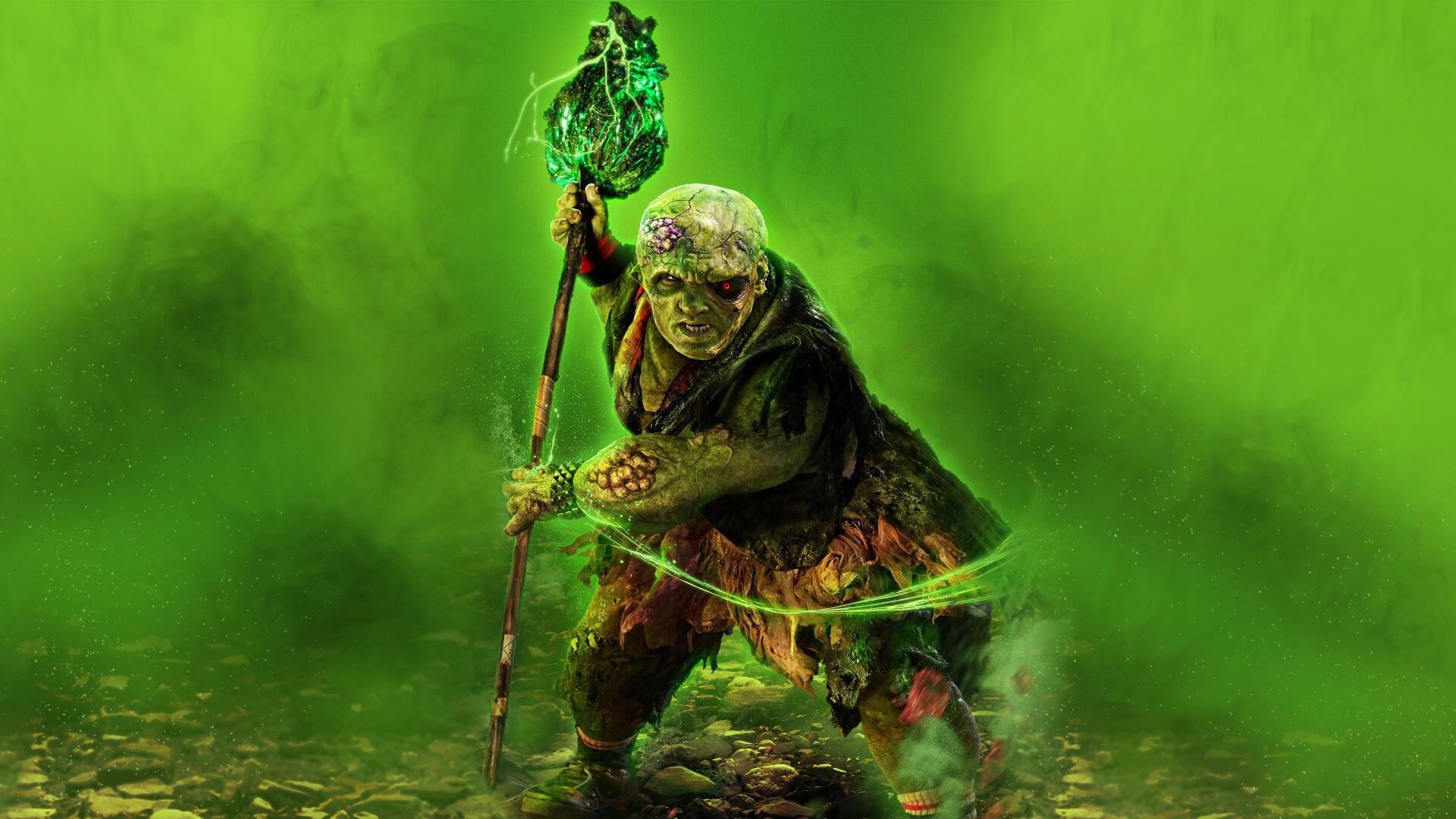 The Toxic Avenger emerges from neon-green mist, clutching a staff above a toxic puddle — 4K Ultra HD PC desktop wallpaper and background.
