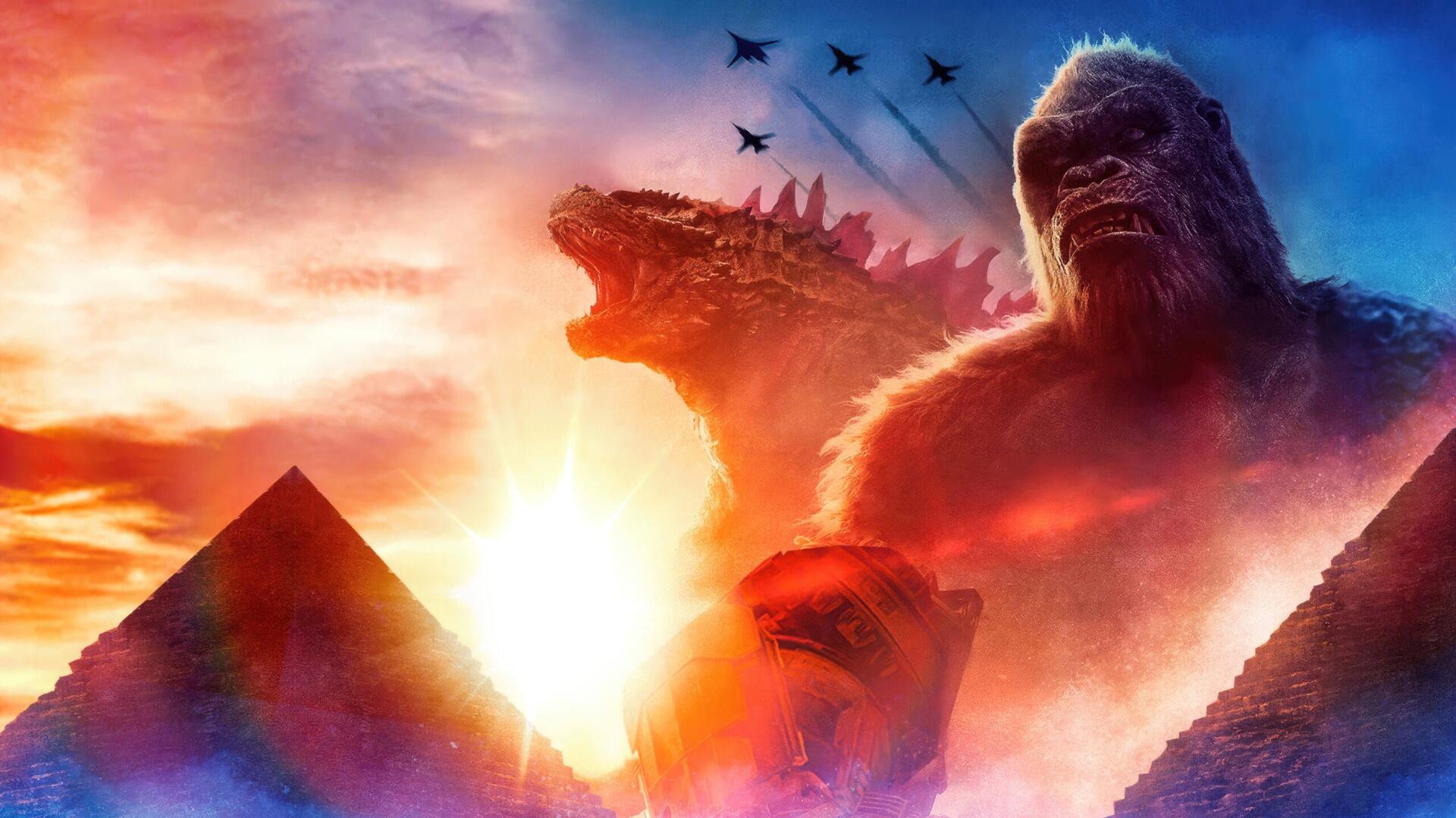 Godzilla x Kong: The New Empire 4K Ultra HD PC desktop wallpaper — Kong and Godzilla tower above pyramids at a fiery sunset while jets streak the sky.