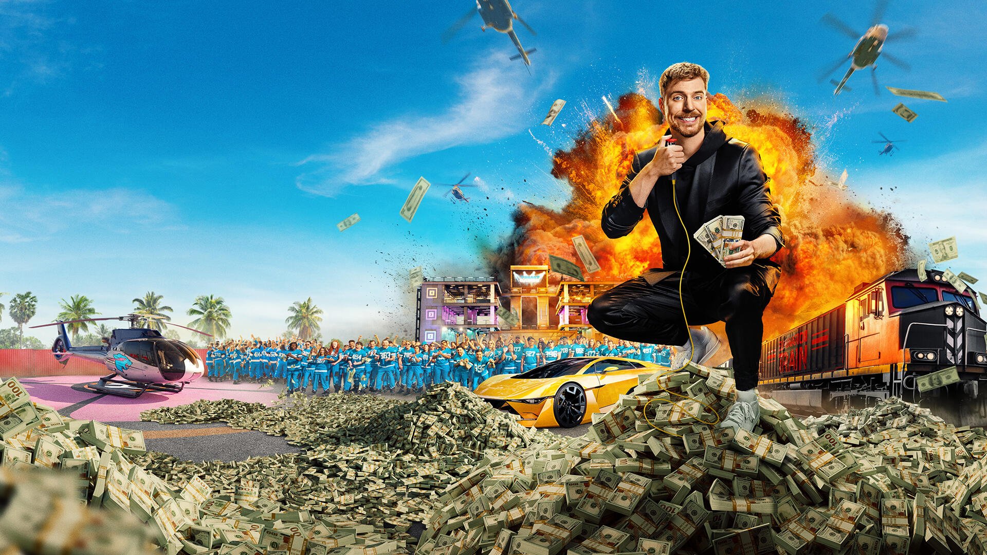 HD PC desktop wallpaper of the Beast Games TV show: host crouching atop a pile of cash amid cars, explosions and cameras on a flashy challenge set beneath a bright blue sky.