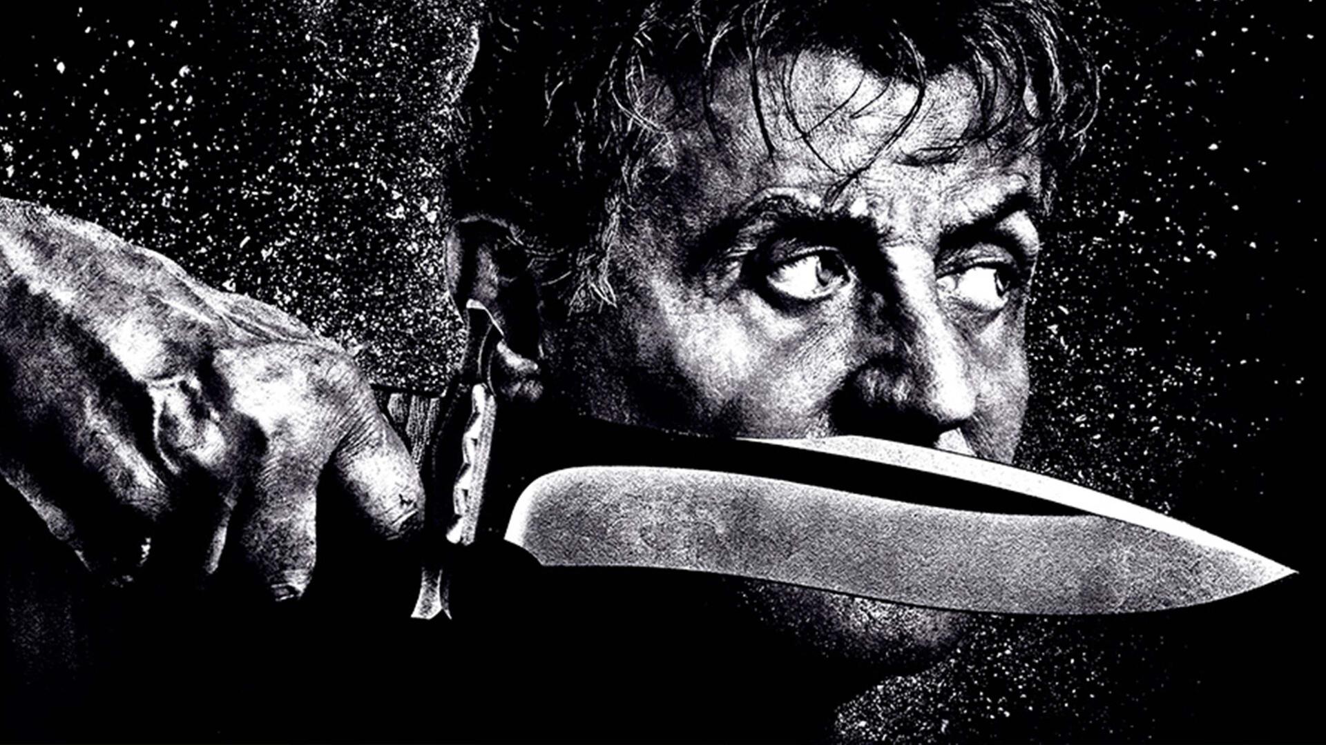 Rambo: Last Blood 4K Ultra HD PC desktop wallpaper — black-and-white close-up of a rugged man holding a large combat knife to his jaw, intense, watchful eyes.