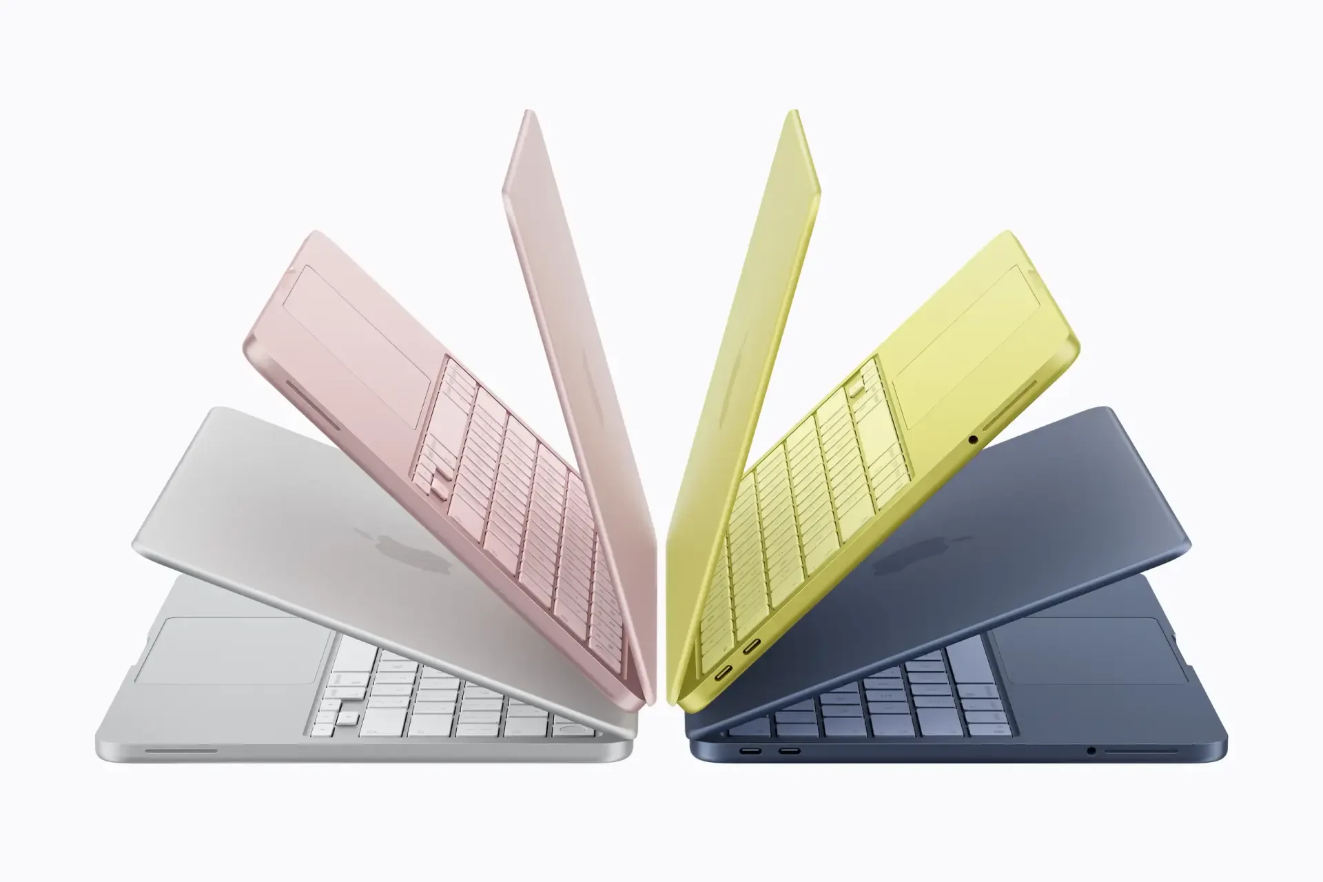 Apple Inc. MacBook and MacBook Neo laptops in pastel colors fanned outward on white, 2K Quad HD PC desktop wallpaper/background.
