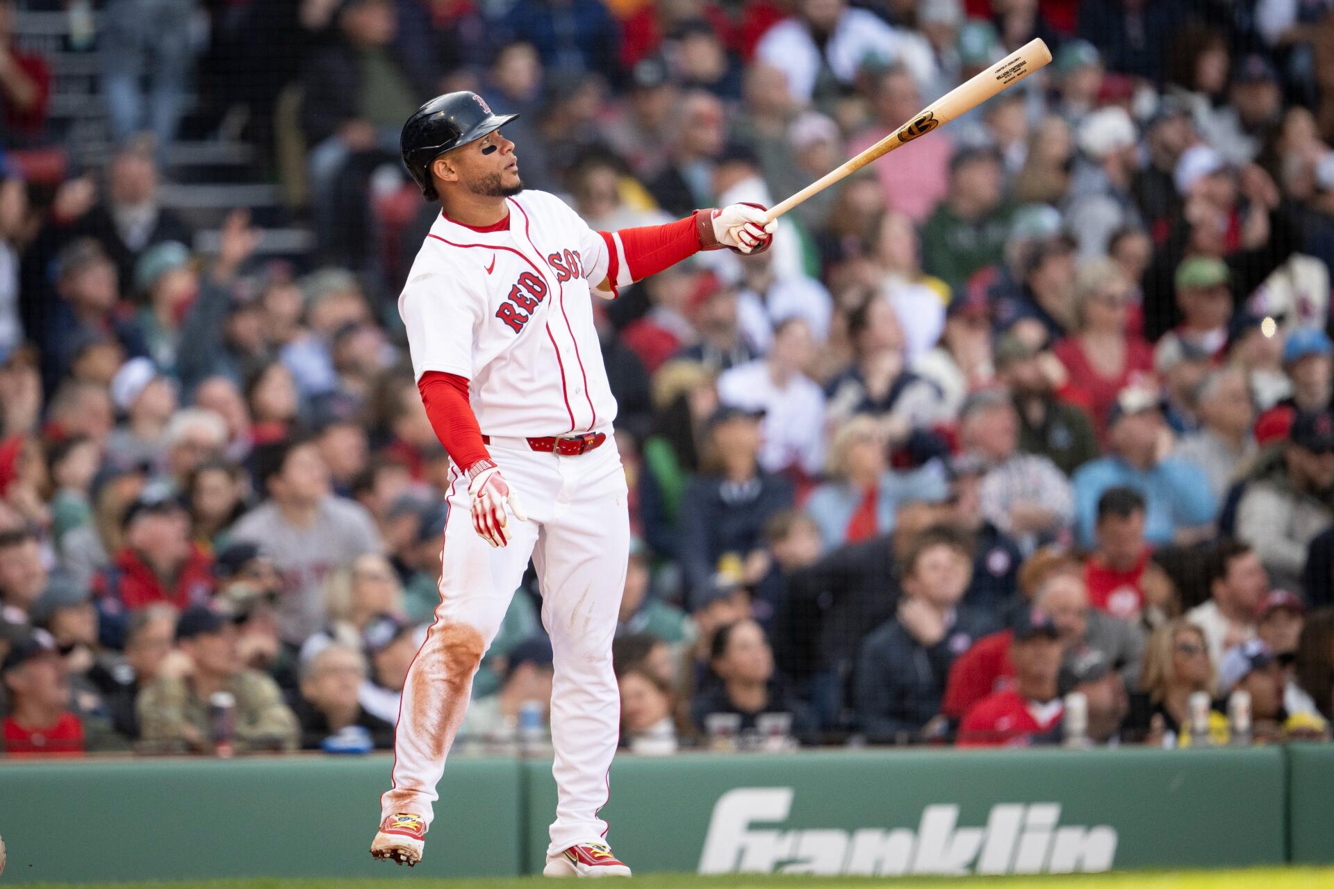 4K Ultra HD PC desktop wallpaper: MLB action — Boston Red Sox batter in white uniform swings at Fenway Park, dirt-streaked pants and a blurred stadium crowd behind.