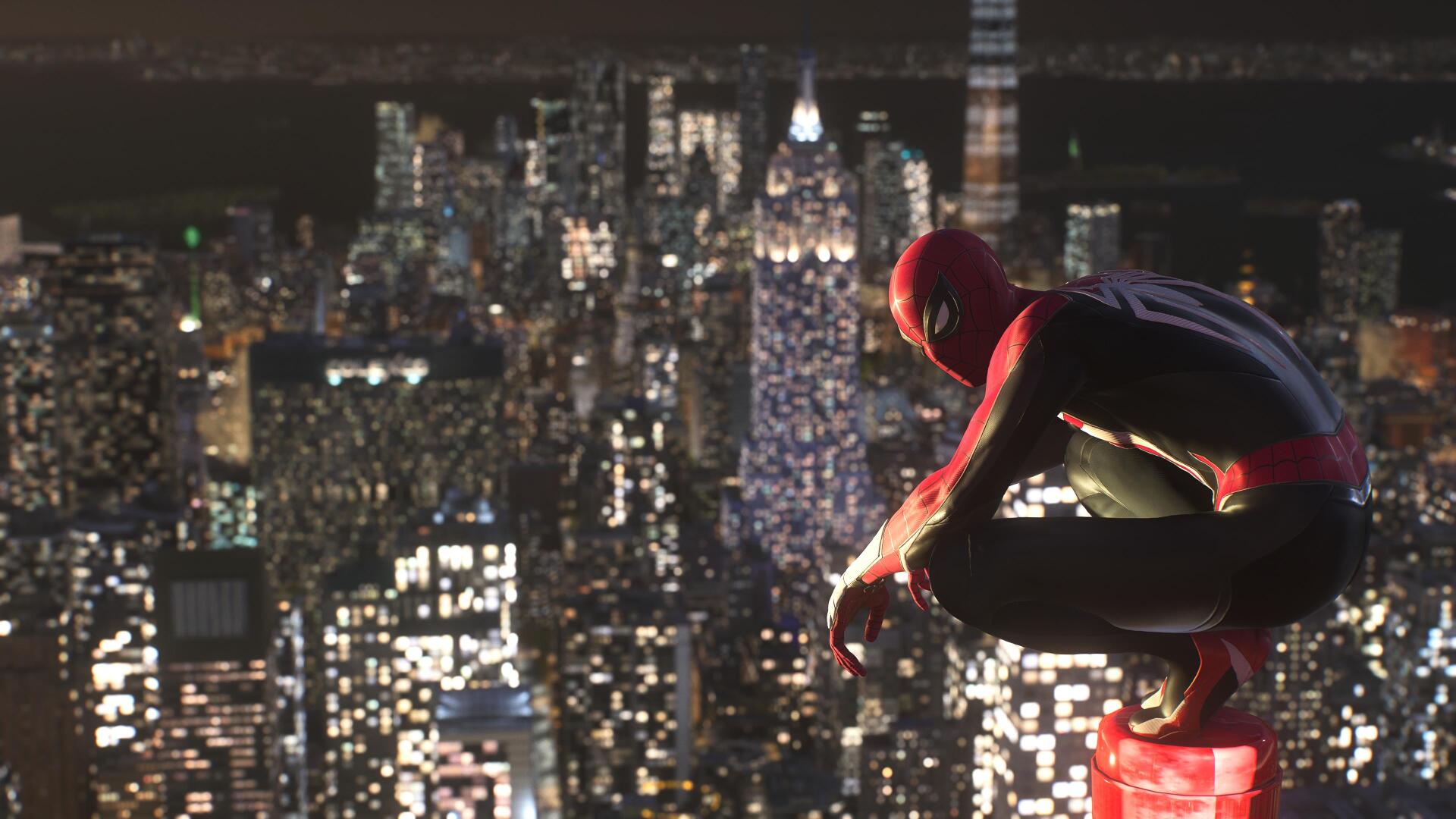 Spider-Man (PS4) perched on a rooftop, overlooking a sparkling nighttime New York skyline — 4K Ultra HD PC desktop wallpaper/background from the video game.