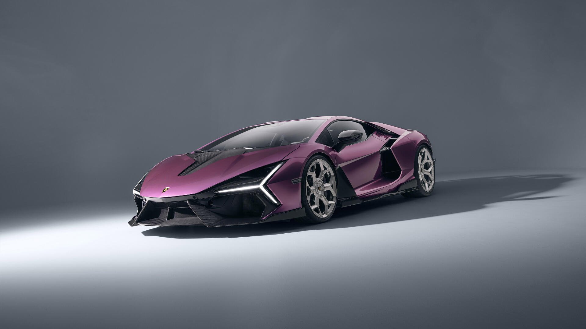 Purple Lamborghini Revuelto on a minimalist grey backdrop — 4K Ultra HD PC desktop wallpaper and background showcasing a sleek purple supercar.