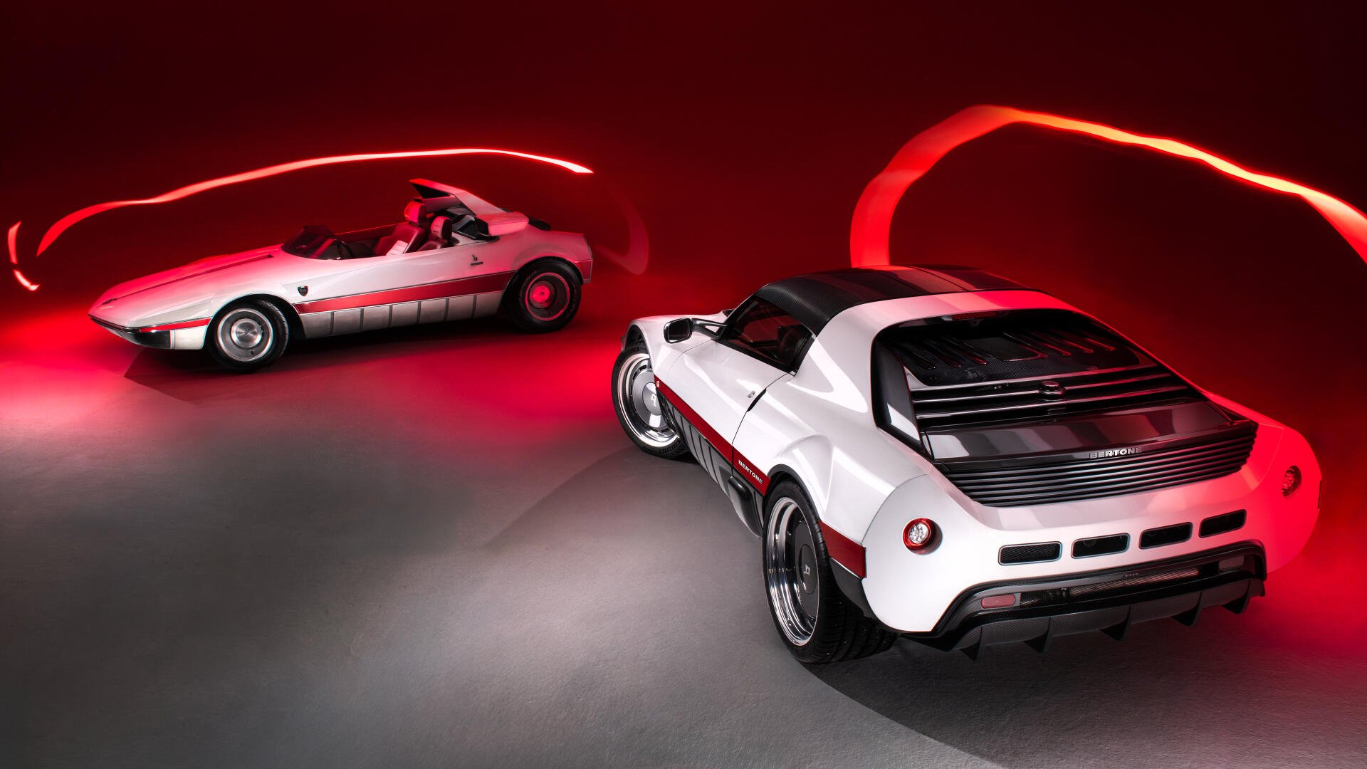 Two Bertone Runabout cars in a red-lit studio, white and red finishes on a glossy floor — 4K Ultra HD PC desktop wallpaper highlighting classic Bertone design.