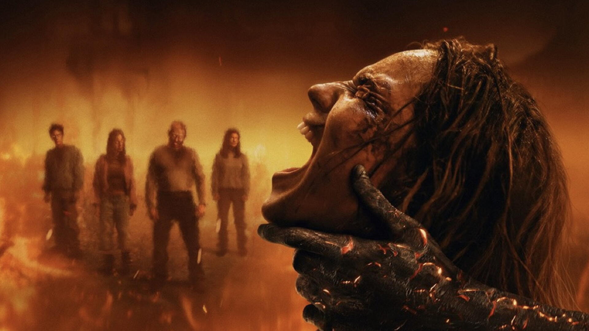Evil Dead 2K Quad HD PC desktop wallpaper and background: fiery horror scene of a demon hand crushing a screaming woman's face as four shadowy figures loom in smoky orange mist.